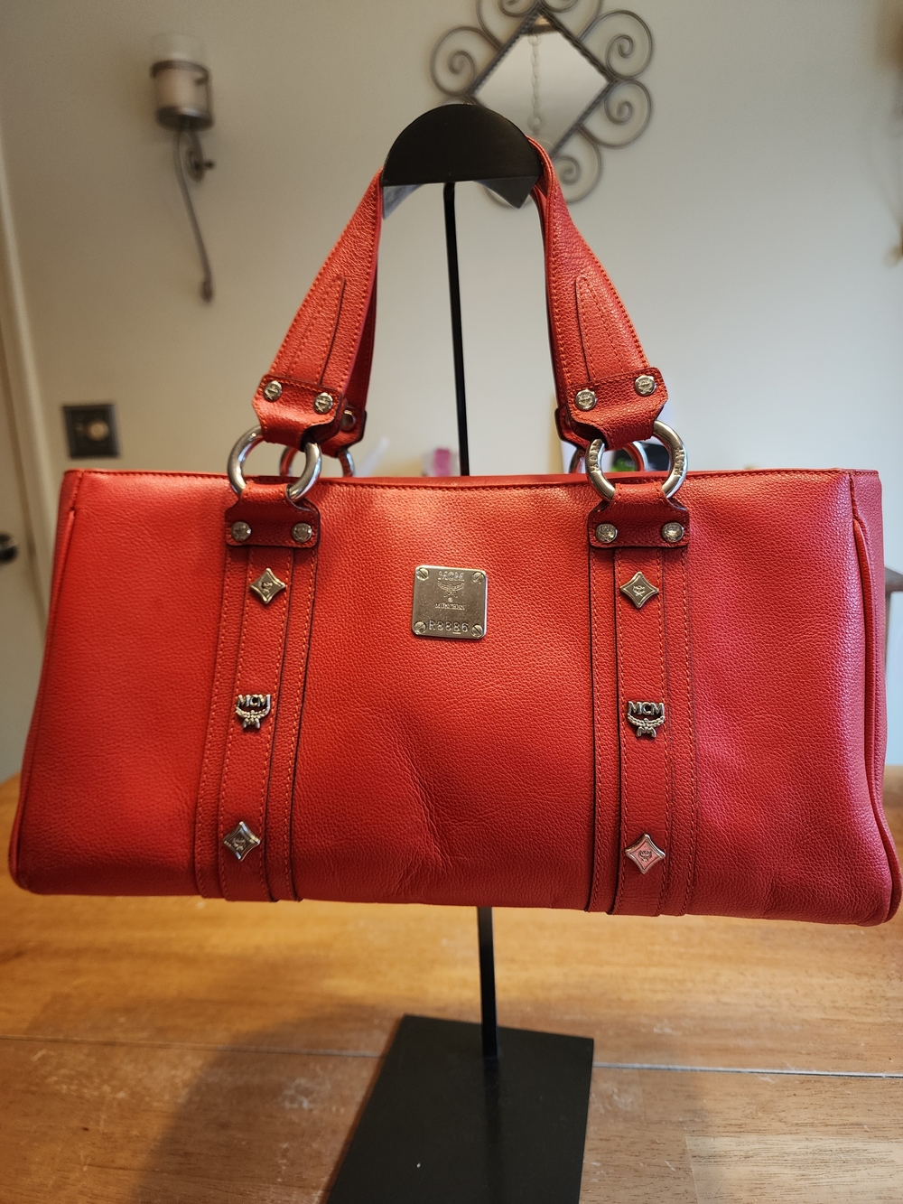 red pebbled leather top-handle handbag by MCM with silver-tone hardware